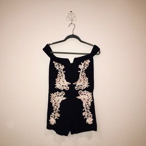 Black bodycon romper with gold detail lacing